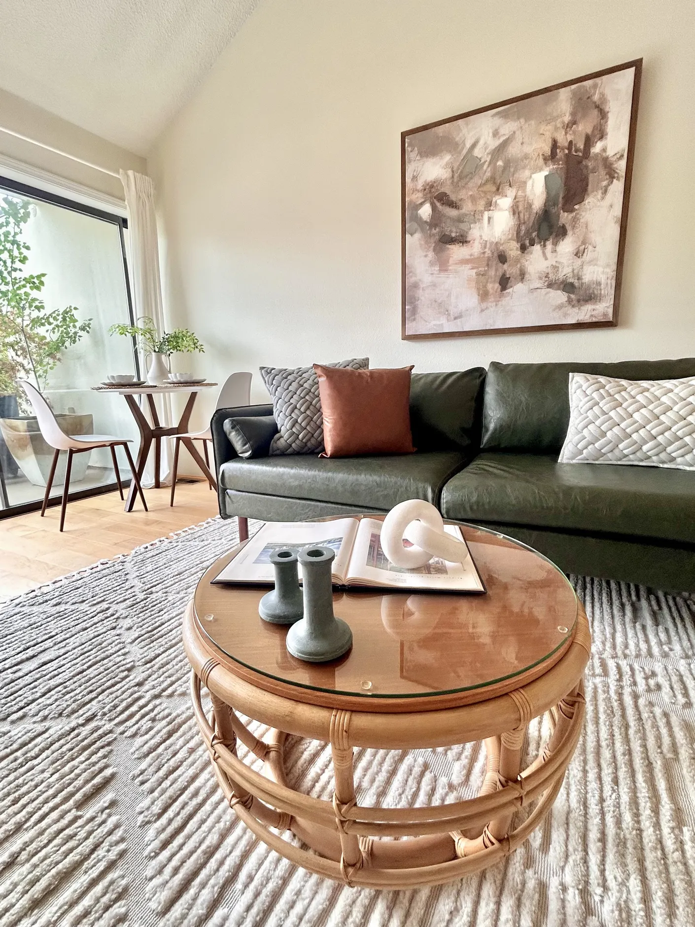 Living room seating with green sofa and round coffee table