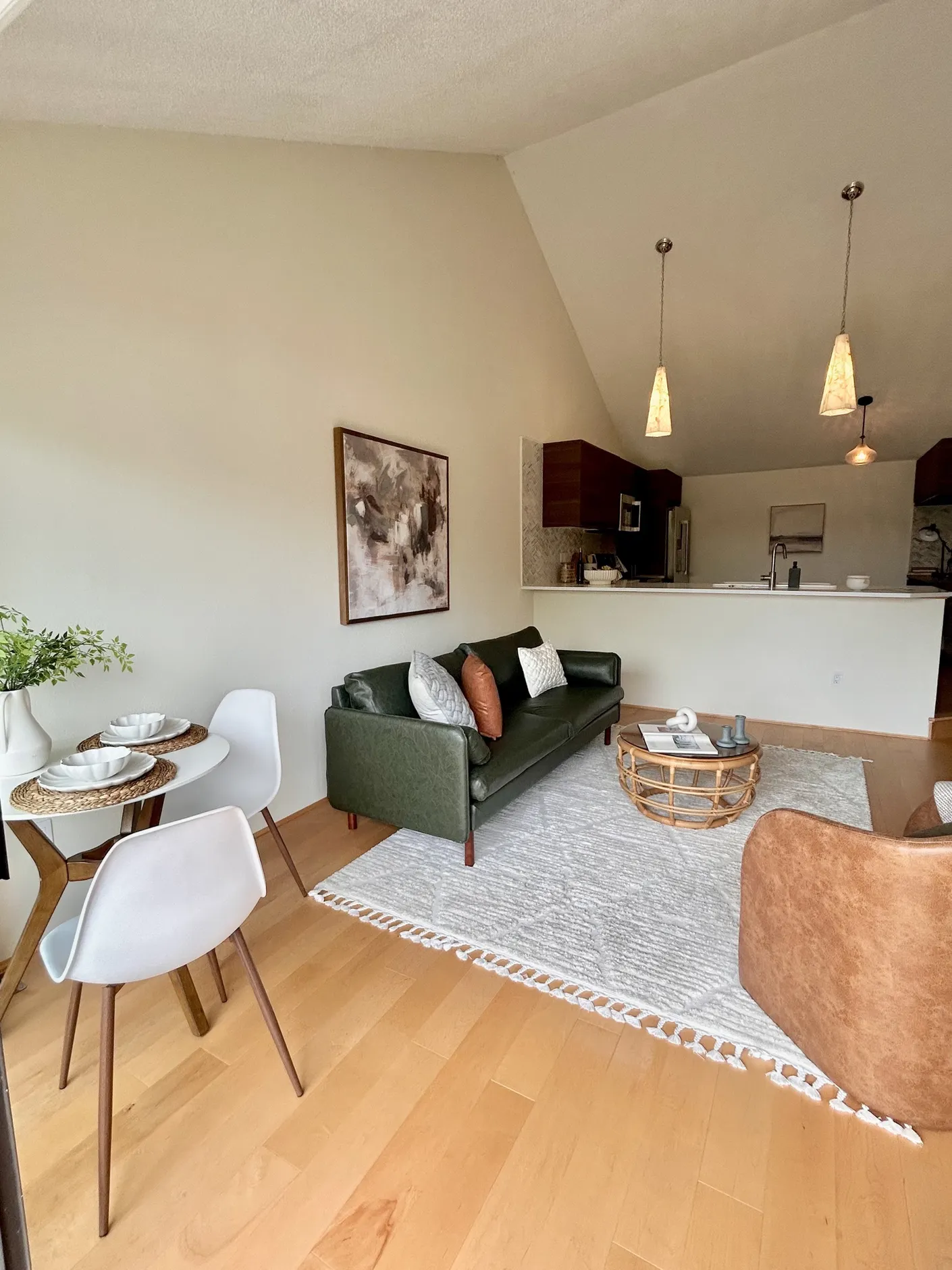 Living room with green sofa and dining nook