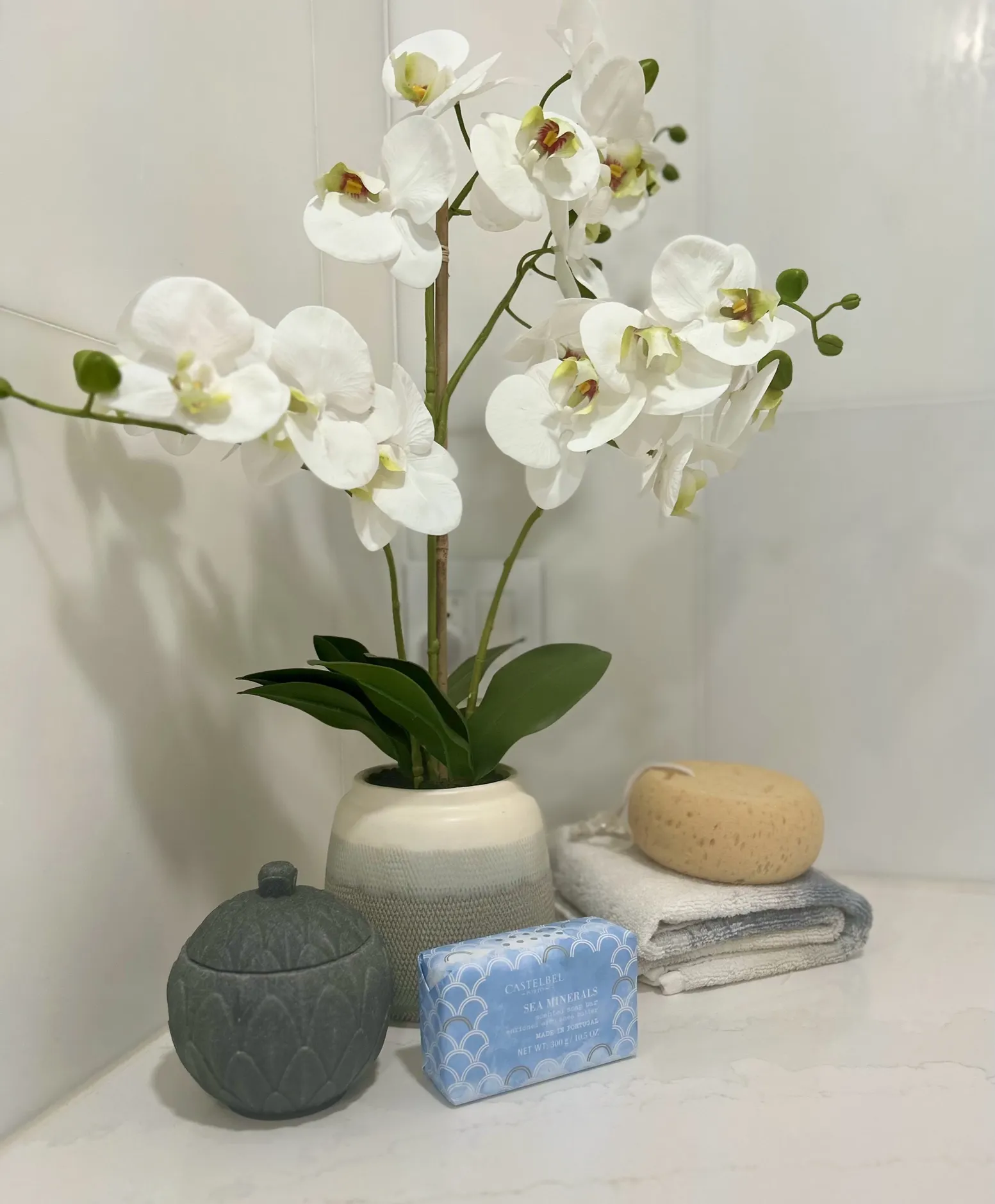 White orchids and bath accessories