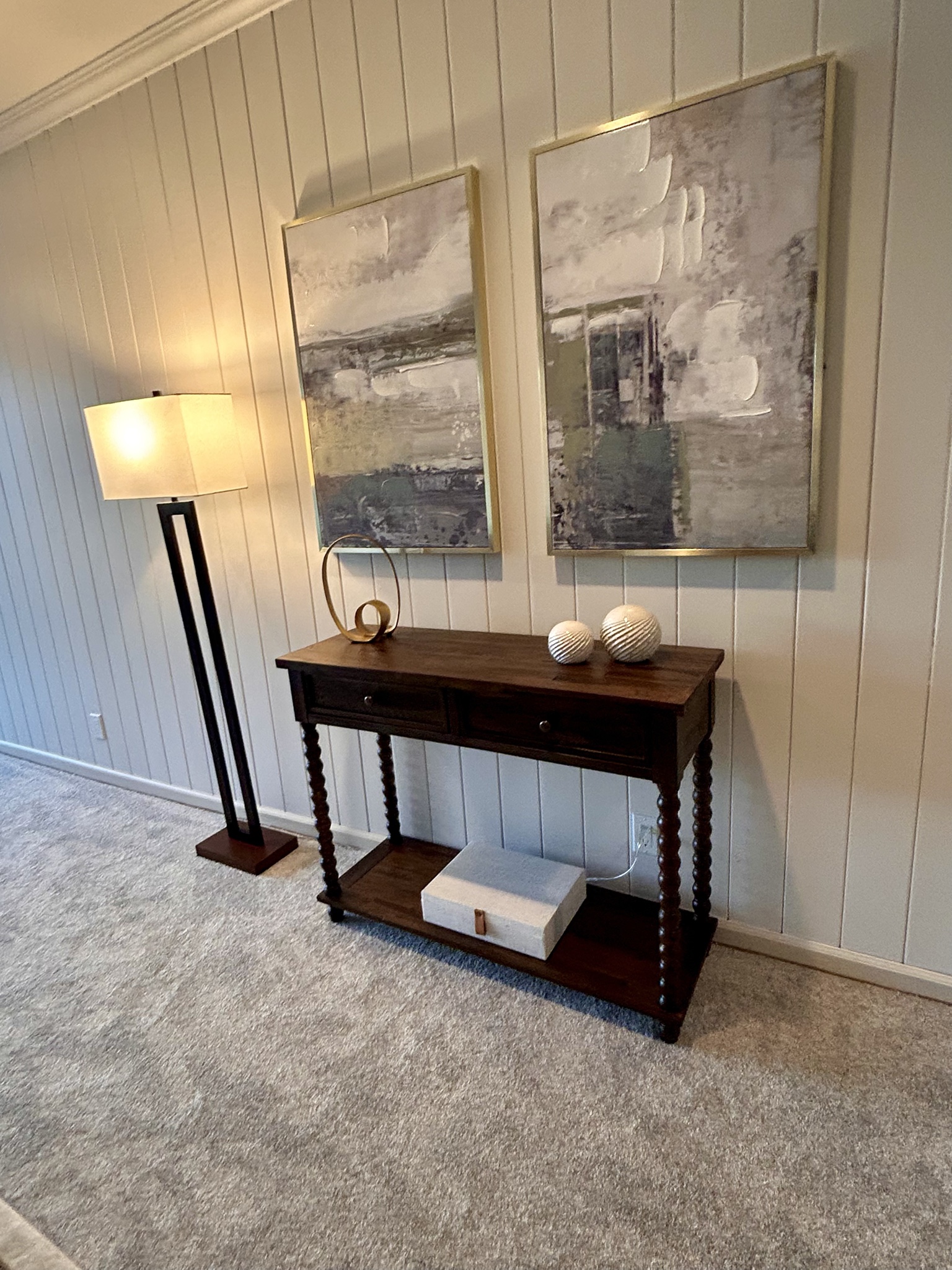Living room console table, floor lamp and framed artwork