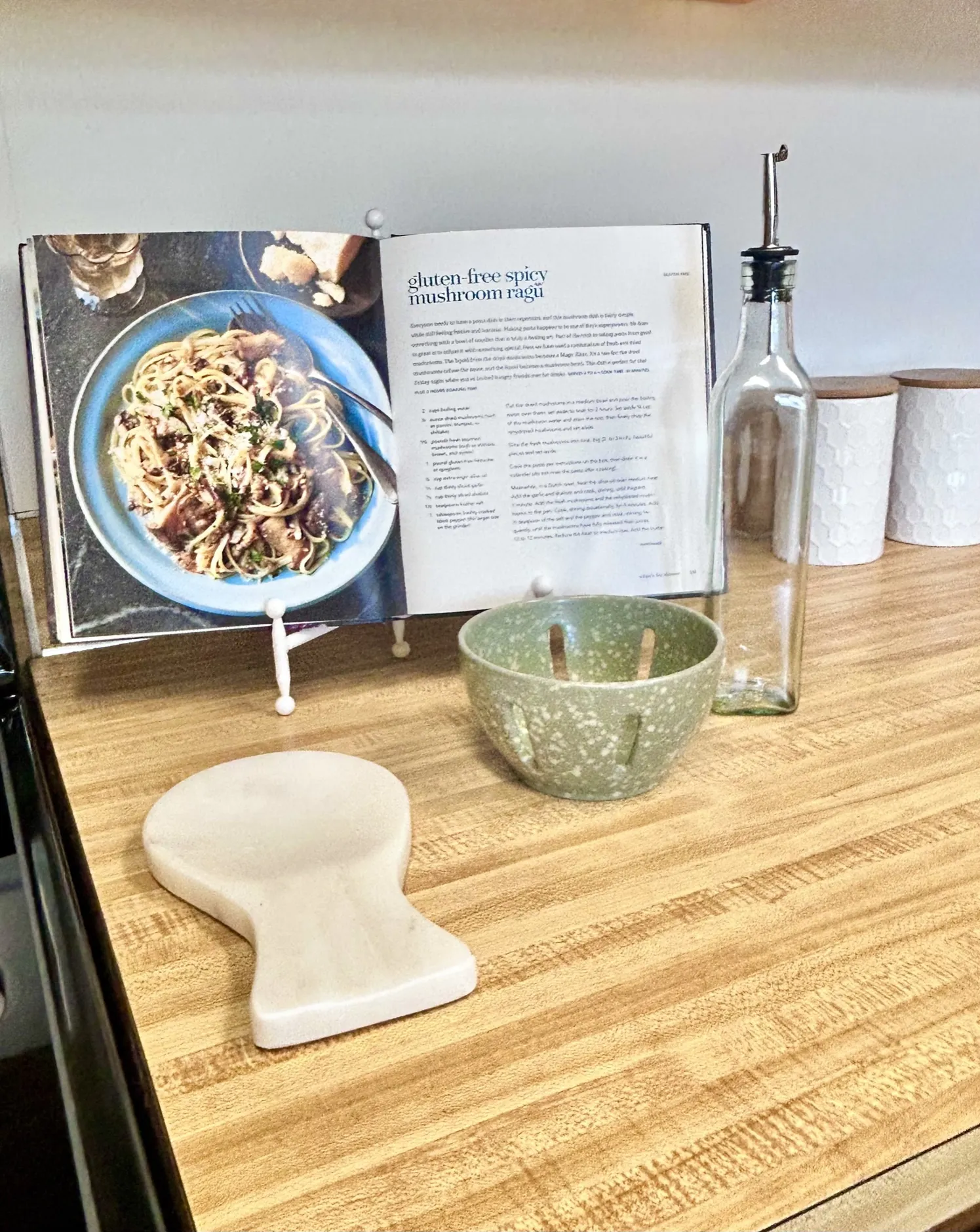 Cookbook and ceramics styled on a kitchen counter