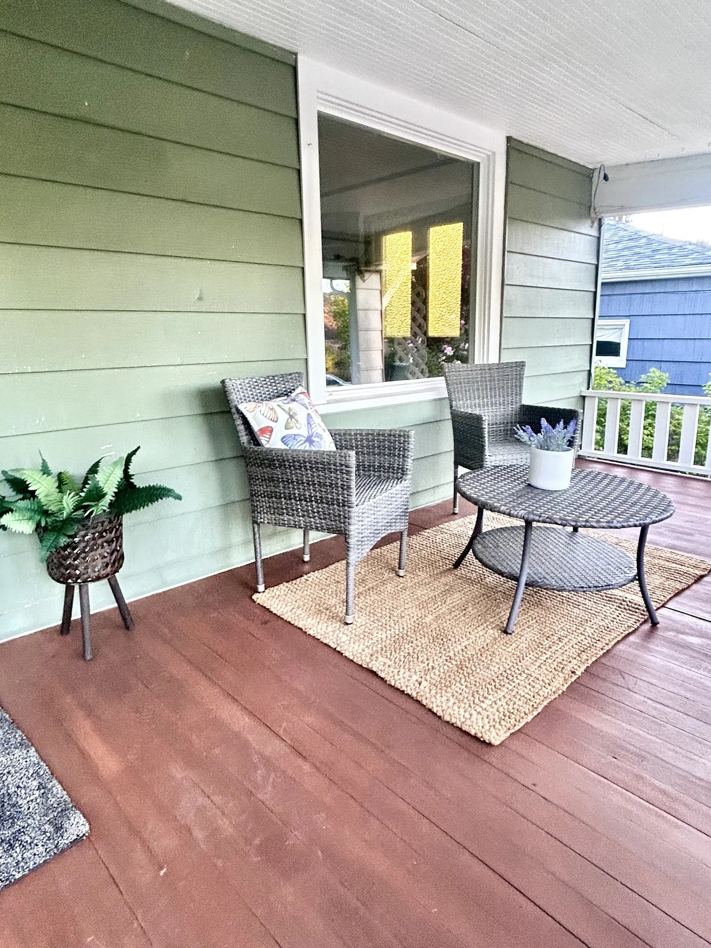 Covered porch with wicker chairs and round table