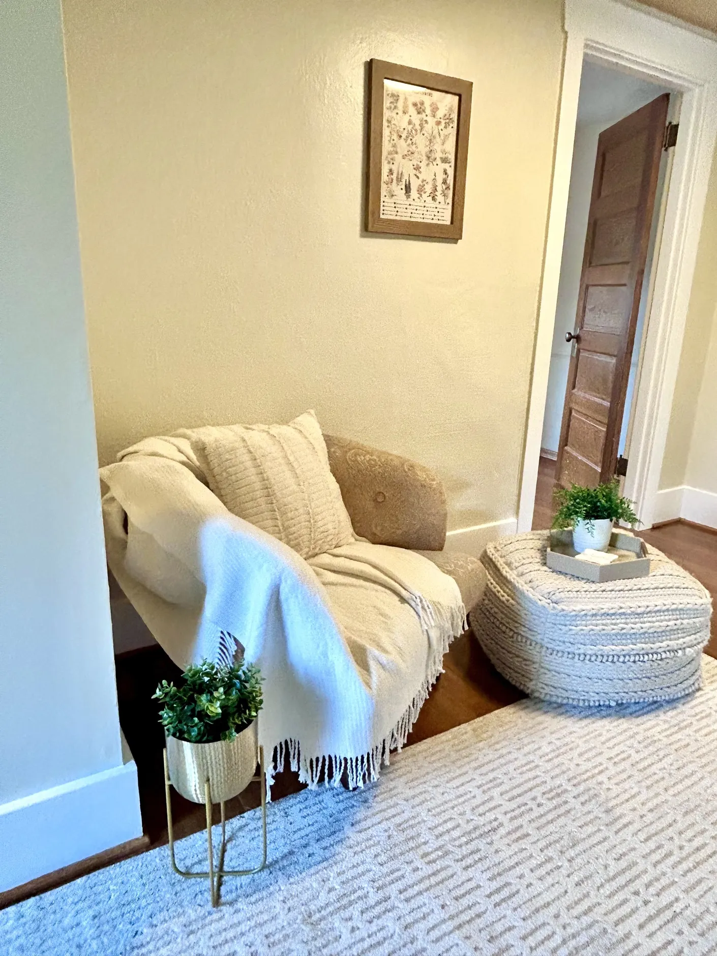 Reading corner with upholstered chair and ottoman