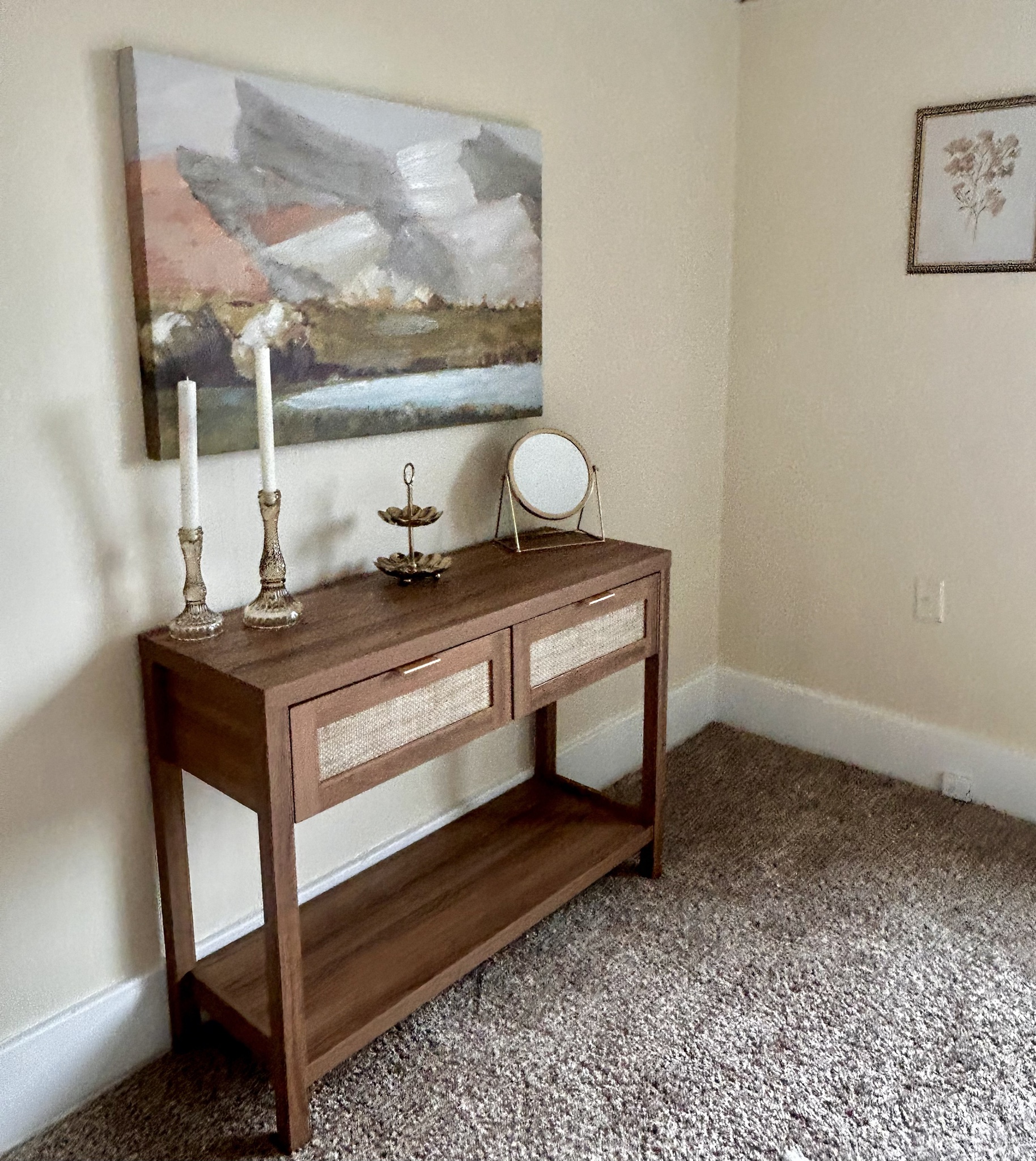 Bedroom console table with artwork, mirror and candlesticks