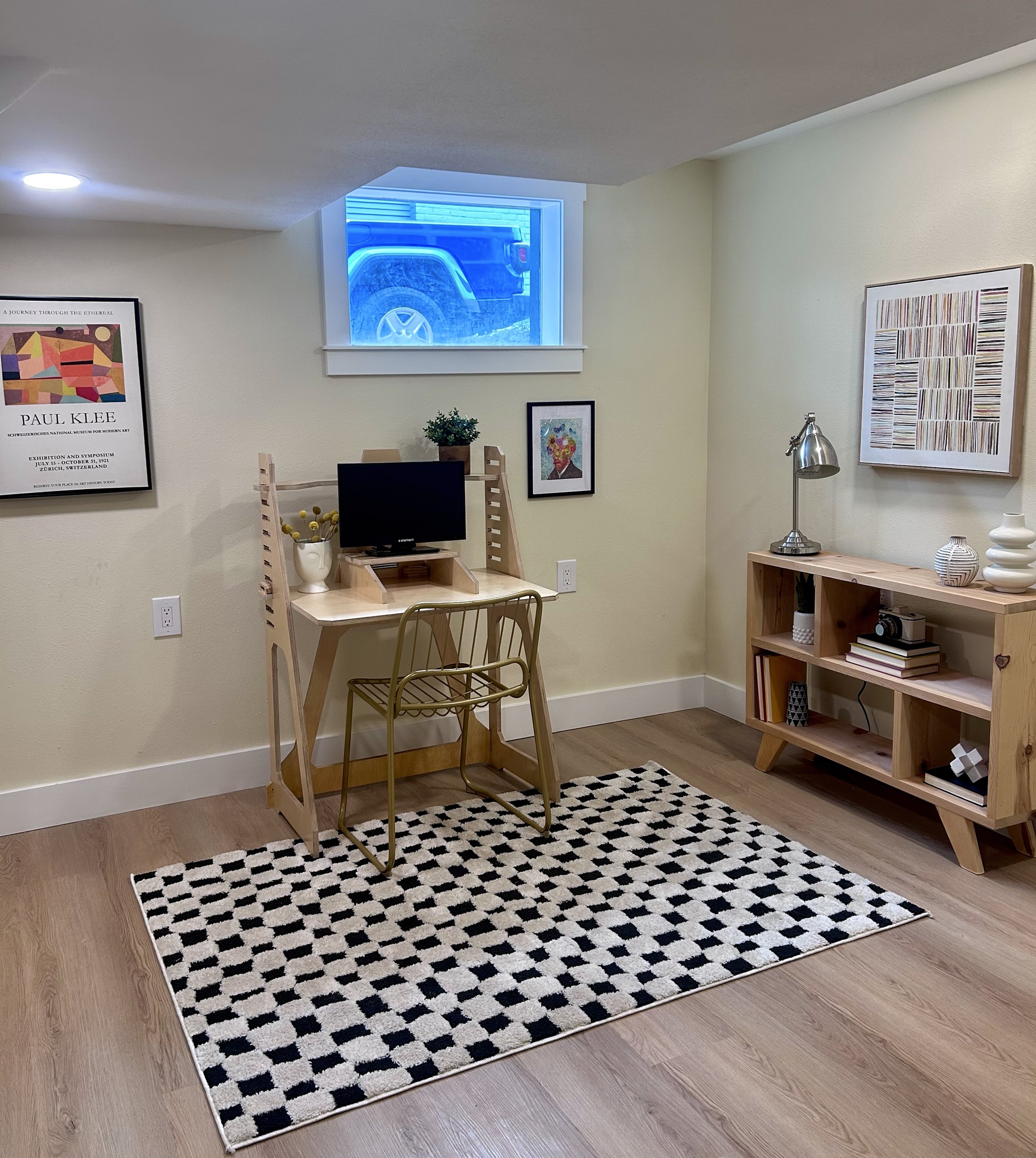 Home office with a writing desk, shelving and a geometric rug