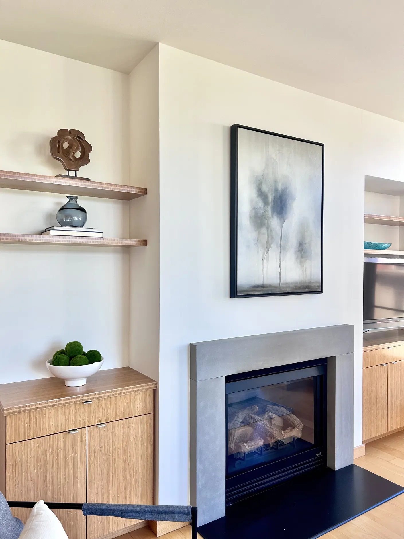 Living room fireplace with artwork and styled shelves