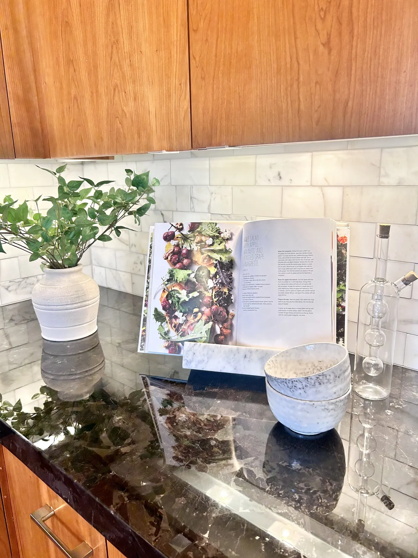 Cookbook and ceramics styled on the kitchen counter