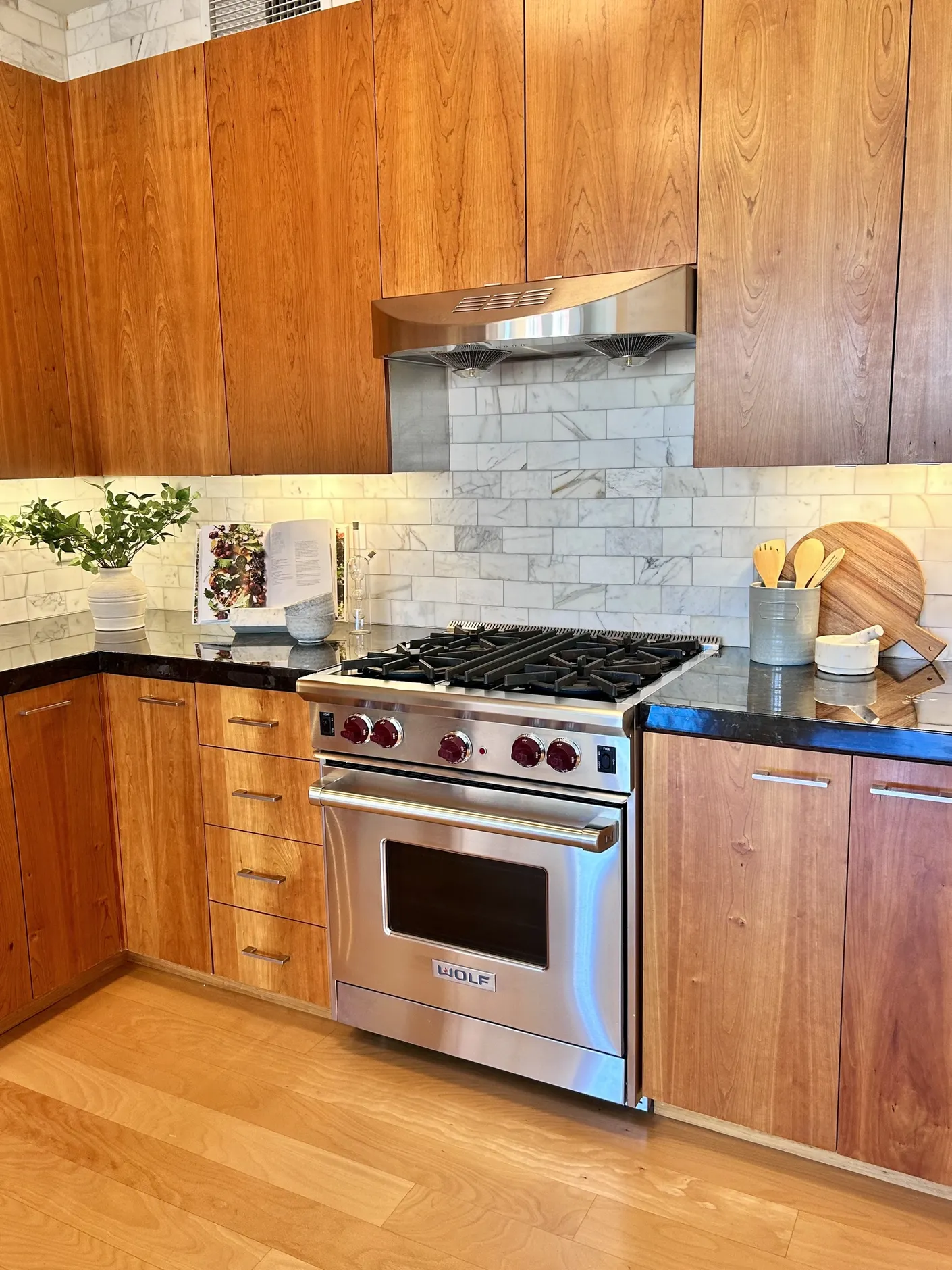 Kitchen with warm wood cabinetry and stainless steel range