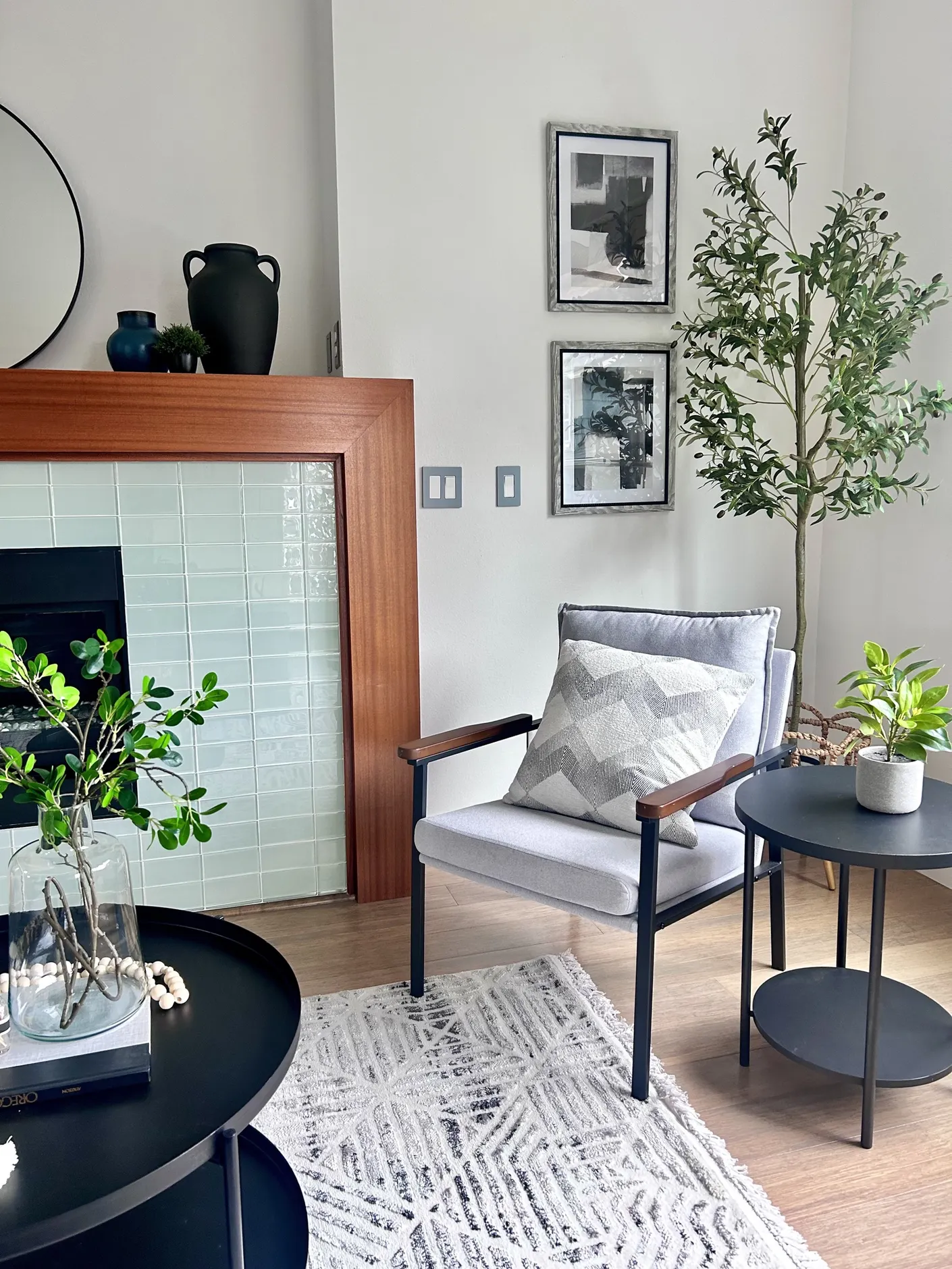 Chair and greenery beside the tiled fireplace