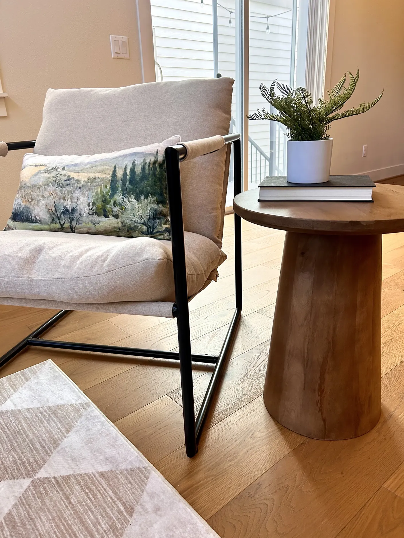 Living room chair with landscape pillow and side table