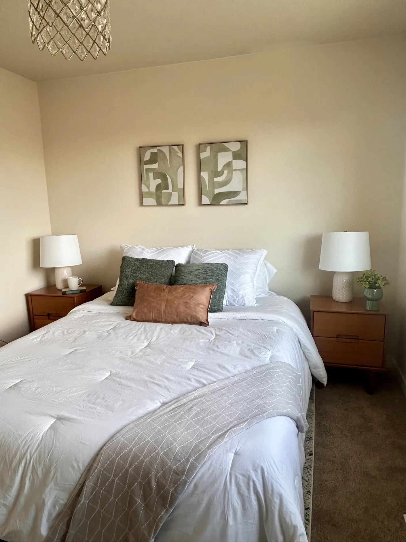 Bedroom with sage and terracotta pillows